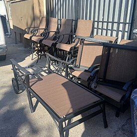 Luxury pool lounge chairs with custom striped cushions and patio umbrellas in a Van Nuys residential estate.